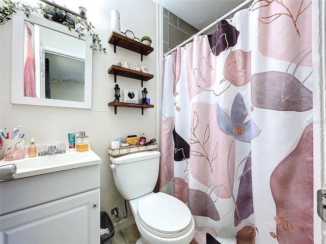 bathroom with curtained shower, vanity, and toilet