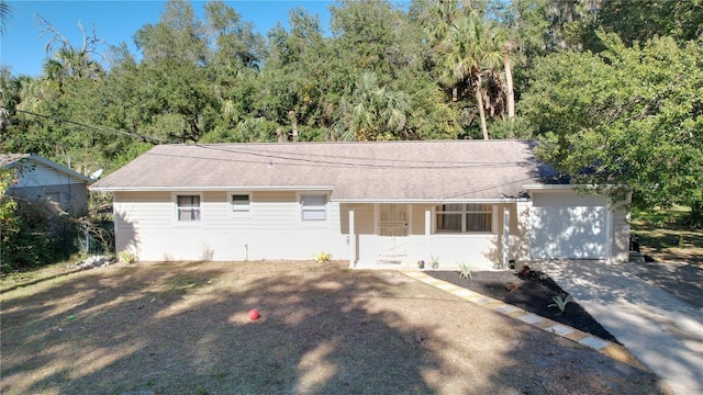 single story home with a garage and driveway