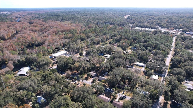 drone / aerial view featuring a forest view