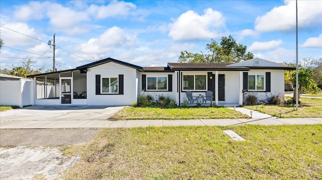 ranch-style home with a front lawn, a porch, fence, and stucco siding