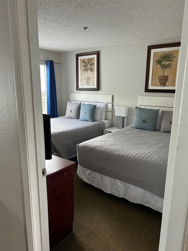 bedroom with carpet and a textured ceiling