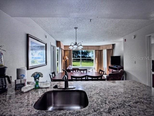 kitchen with a chandelier and sink