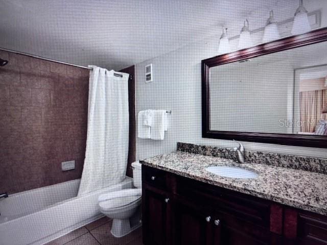 full bathroom with shower / bath combo with shower curtain, vanity, tile patterned flooring, and toilet