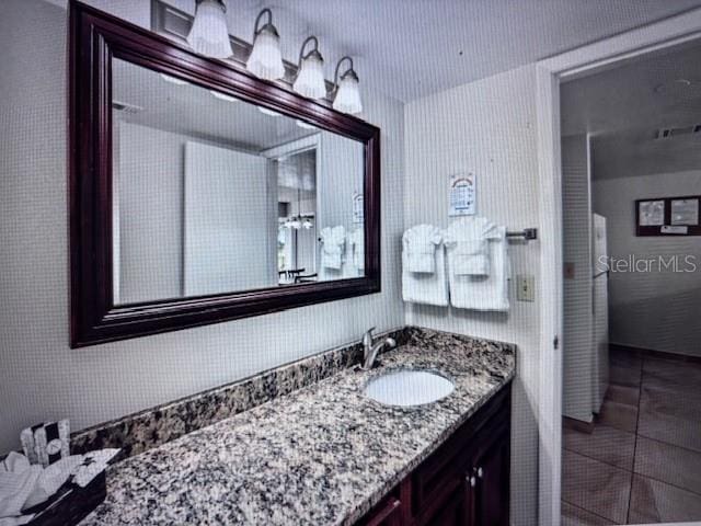 bathroom with tile patterned floors and vanity