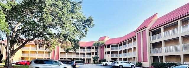 6337 Parc Corniche Dr Unit 2101, Orlando, FL 32821 - view of apartment building / complex with uncovered parking