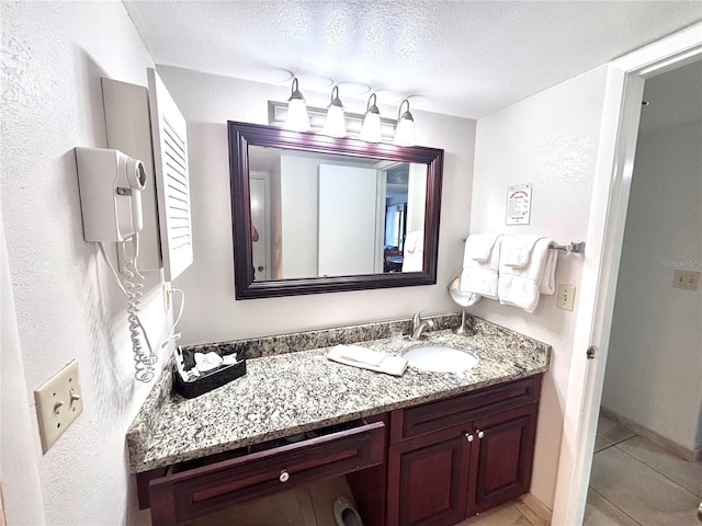 6337 Parc Corniche Dr Unit 2101, Orlando, FL 32821 - bathroom featuring vanity, tile patterned floors, and a textured ceiling