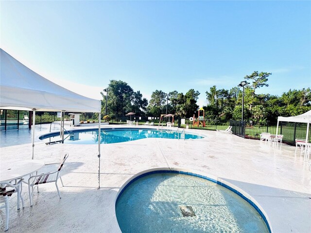 6337 Parc Corniche Dr Unit 2101, Orlando, FL 32821 - community pool featuring a patio