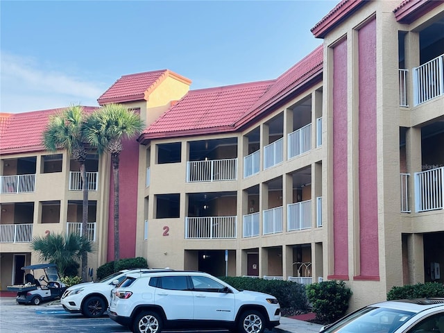 6337 Parc Corniche Dr Unit 2101, Orlando, FL 32821 - view of apartment building / complex featuring uncovered parking