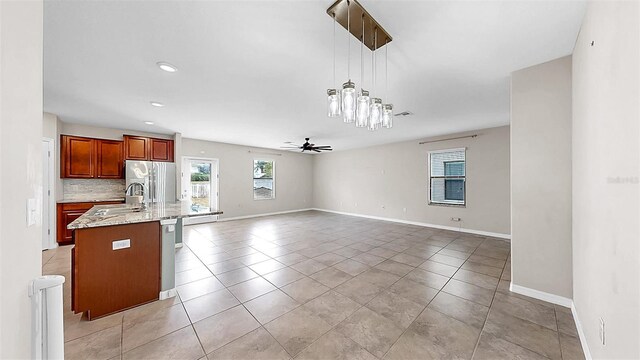 11201 Hudson Hills Ln, Riverview, FL 33579 - kitchen featuring a sink, stainless steel fridge, a ceiling fan, baseboards, and recessed lighting