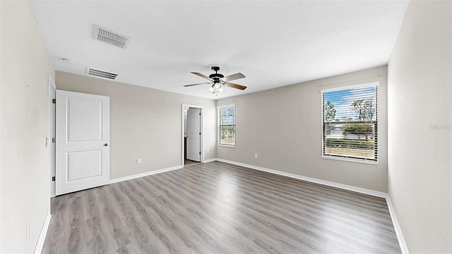 11201 Hudson Hills Ln, Riverview, FL 33579 - unfurnished bedroom featuring multiple windows, wood finished floors, and baseboards