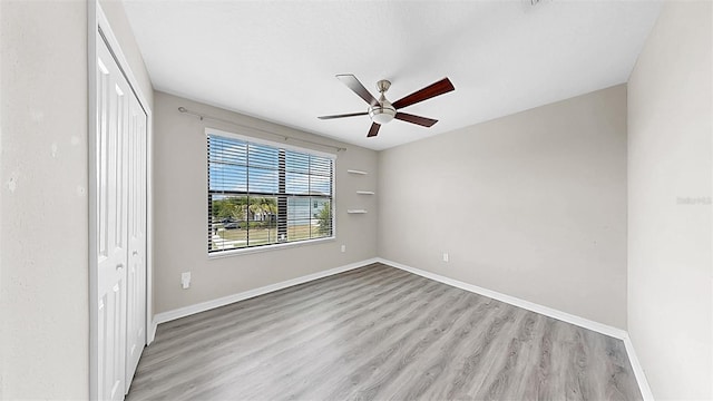 11201 Hudson Hills Ln, Riverview, FL 33579 - empty room with a ceiling fan, wood finished floors, and baseboards