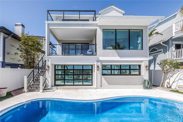 8505 Blind Pass Dr, Treasure Island, FL 33706 - rear view of property featuring stairs, fence, and stucco siding