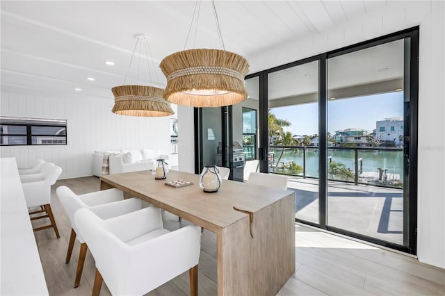 8505 Blind Pass Dr, Treasure Island, FL 33706 - dining space featuring a water view and light wood-style floors
