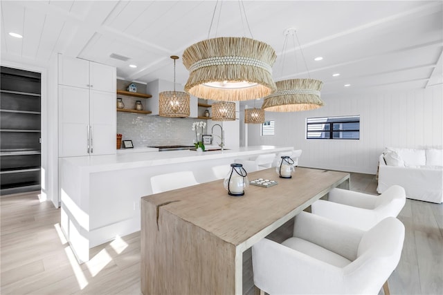 8505 Blind Pass Dr, Treasure Island, FL 33706 - dining room featuring light wood finished floors, beamed ceiling, and recessed lighting