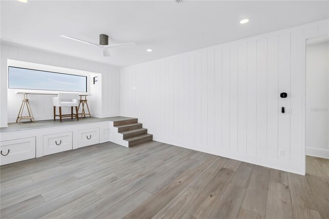 8505 Blind Pass Dr, Treasure Island, FL 33706 - empty room with light wood-style flooring, ceiling fan, and stairs