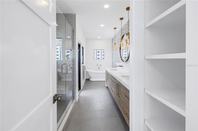 8505 Blind Pass Dr, Treasure Island, FL 33706 - bathroom with a shower stall, recessed lighting, concrete flooring, a freestanding bath, and double vanity