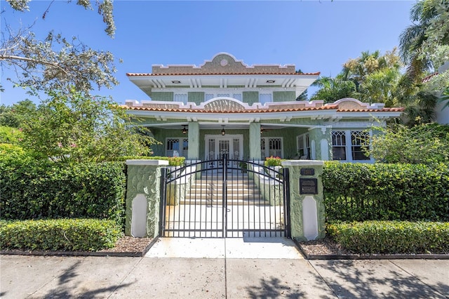 mediterranean / spanish-style house with a gate and fence