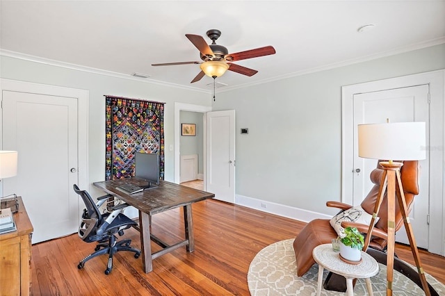 office with visible vents, ornamental molding, ceiling fan, wood finished floors, and baseboards