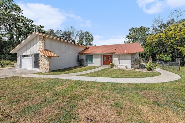 view of front of property with a garage and a front lawn