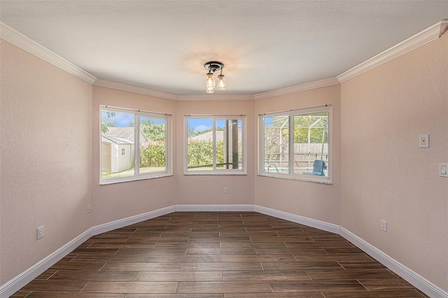 spare room with crown molding, dark hardwood / wood-style flooring, and a textured ceiling