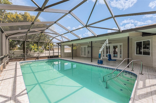 view of swimming pool with french doors, glass enclosure, ceiling fan, and a patio area