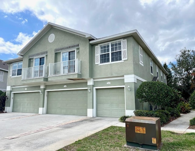 view of front of house featuring a garage and a balcony