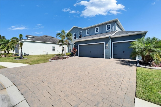 view of front facade featuring a front lawn and decorative driveway