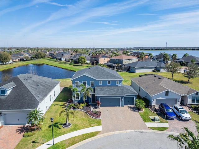 drone / aerial view featuring a residential view and a water view