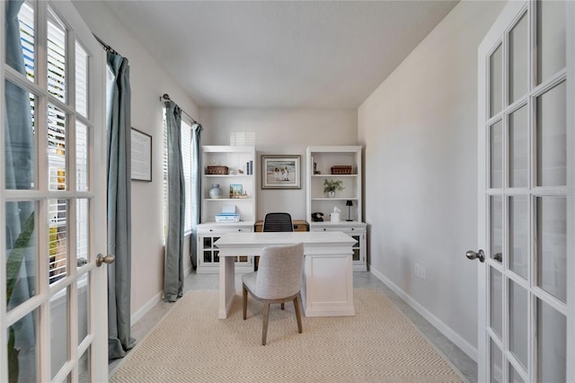 office with baseboards and french doors