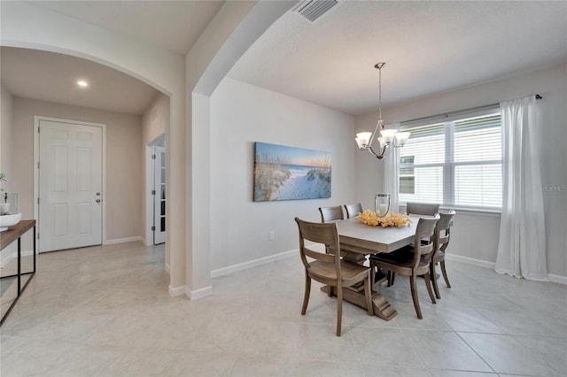 dining space featuring baseboards, visible vents, arched walkways, an inviting chandelier, and recessed lighting