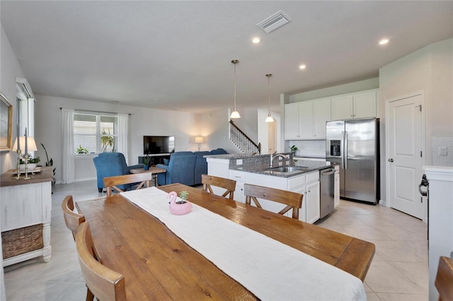 dining area featuring light tile patterned floors, stairway, visible vents, and recessed lighting