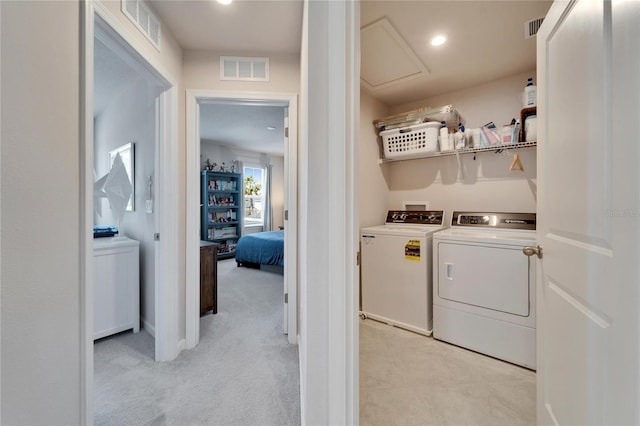 washroom featuring laundry area, washing machine and dryer, and visible vents