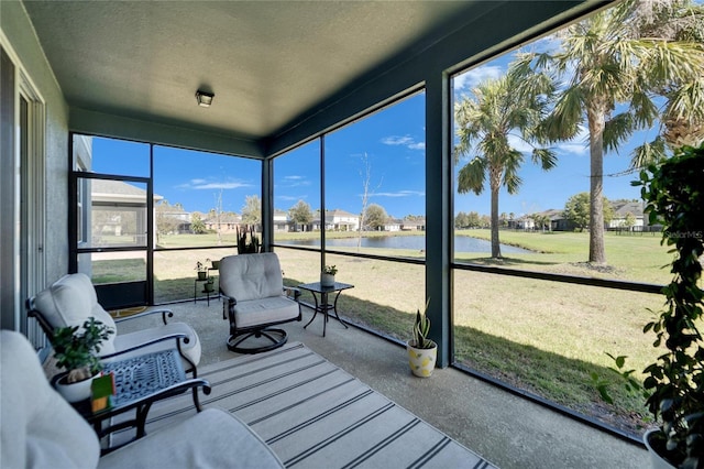 sunroom / solarium featuring a water view