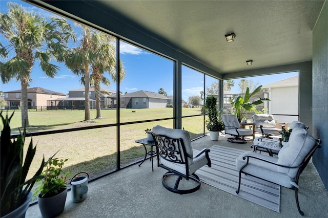 sunroom featuring a residential view