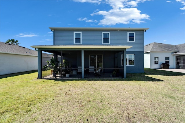 rear view of house with a sunroom and a lawn