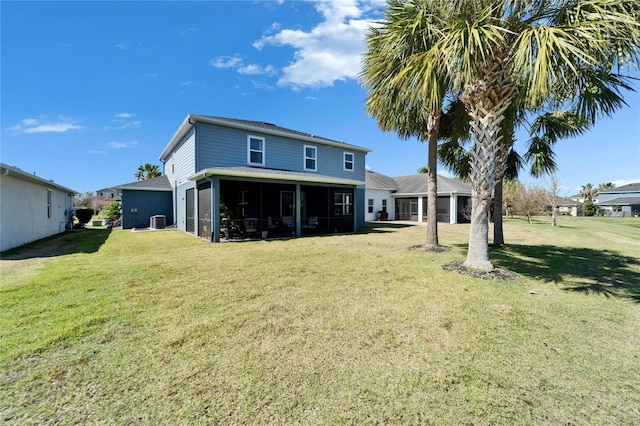 back of property with a garage, a sunroom, a yard, and central AC unit