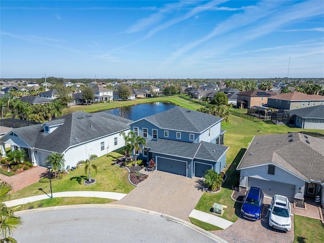 drone / aerial view with a water view and a residential view