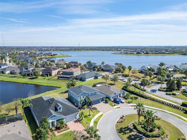 drone / aerial view with a water view and a residential view