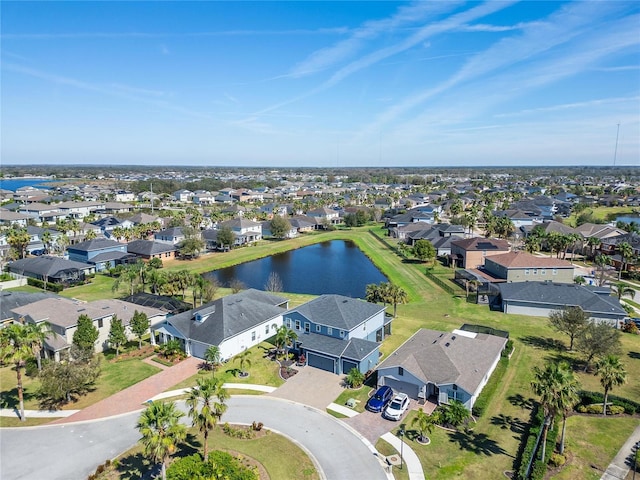 drone / aerial view featuring a water view and a residential view