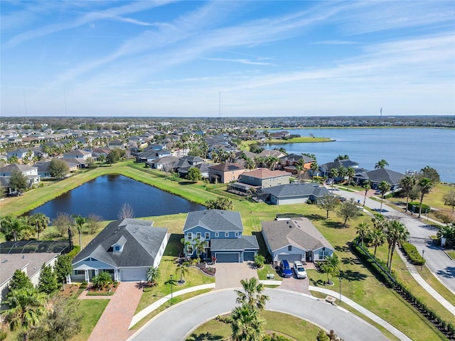 birds eye view of property with a water view and a residential view