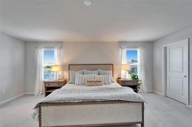 bedroom featuring light colored carpet, baseboards, and multiple windows