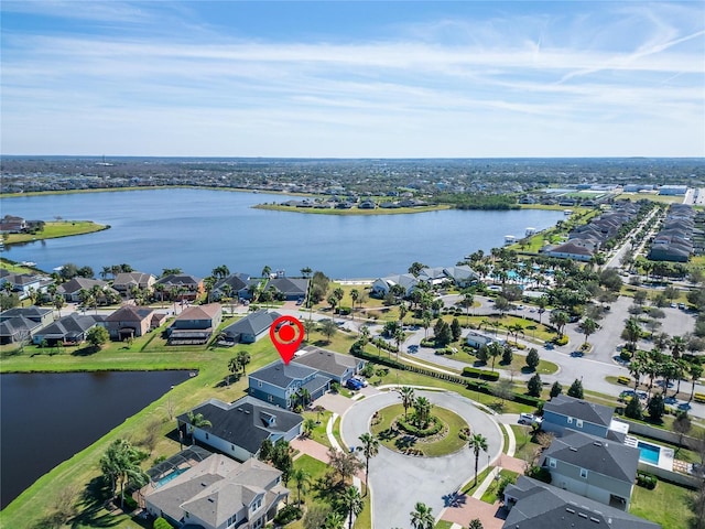 drone / aerial view with a water view and a residential view