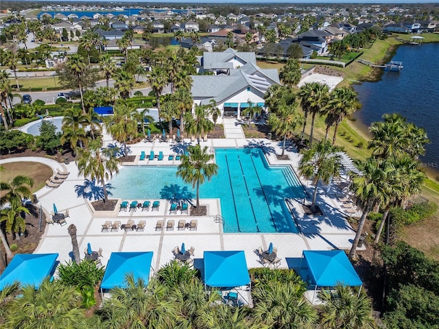 birds eye view of property with a water view and a residential view