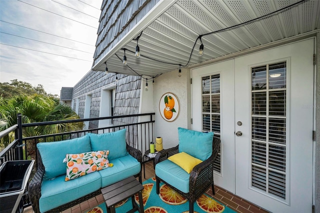 balcony with french doors and outdoor lounge area