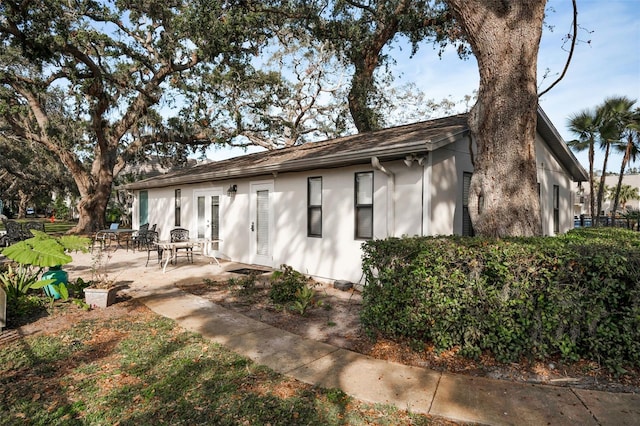 back of house featuring a patio and french doors