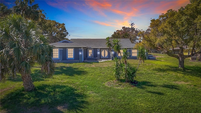 ranch-style house featuring a yard