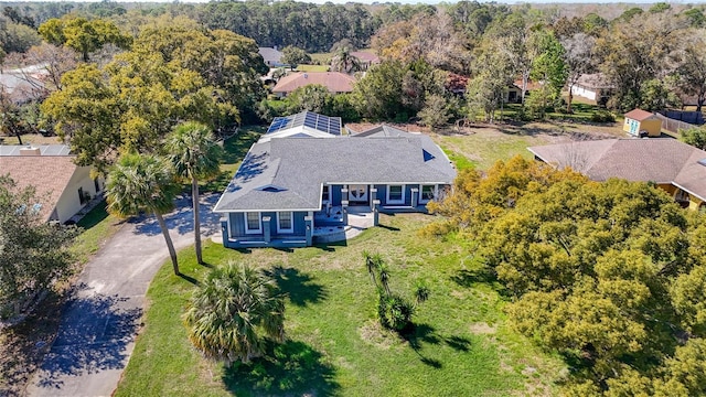 birds eye view of property with a wooded view