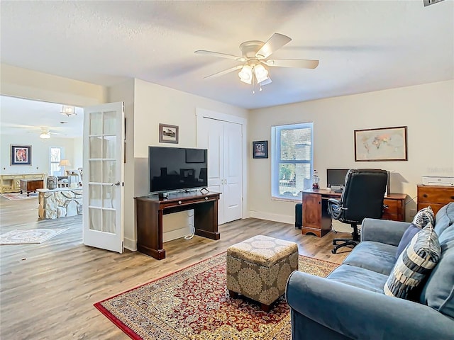 office area featuring visible vents, baseboards, ceiling fan, french doors, and light wood-style floors