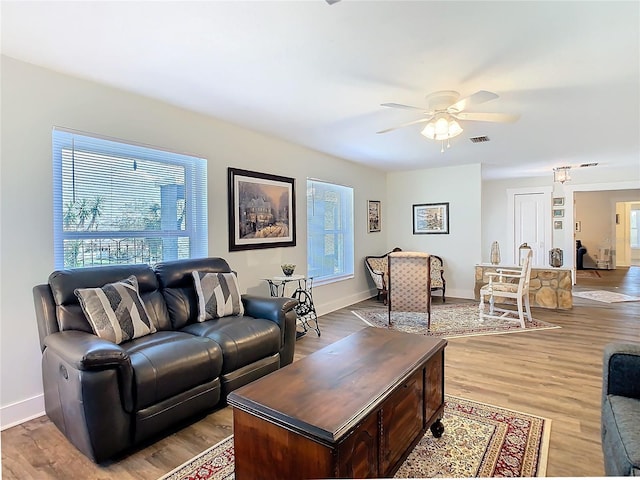 living area with a healthy amount of sunlight and light wood-style floors