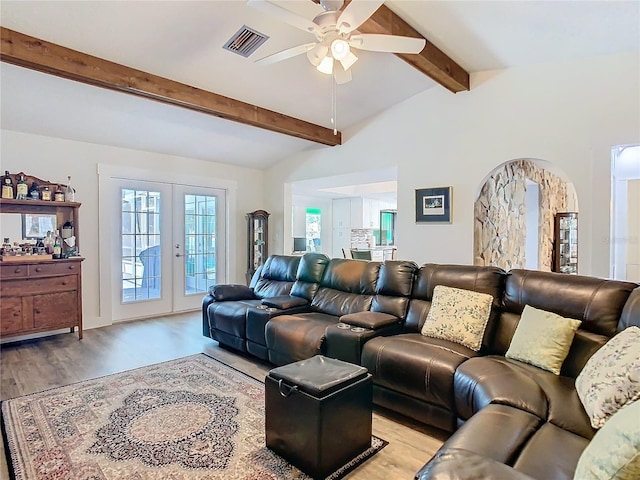 living room featuring visible vents, a ceiling fan, vaulted ceiling with beams, french doors, and light wood-style floors